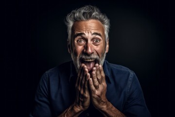 Fototapeta premium Medium shot portrait photography of a satisfied mature man making a surprise gesture by covering one's mouth against a deep indigo background. With generative AI technology