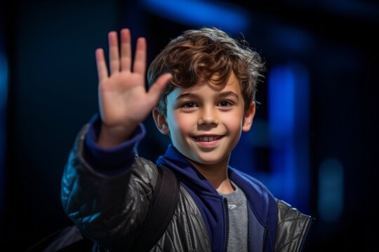 Medium shot portrait photography of a glad kid male waving with the hand against a deep indigo background. With generative AI technology