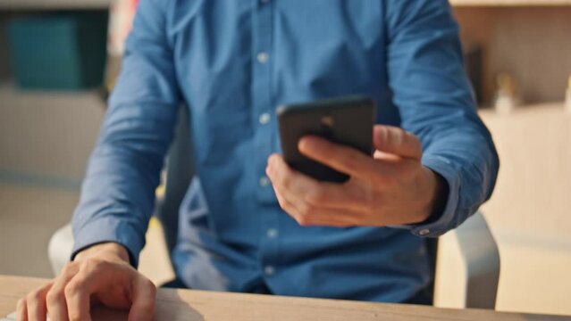 Man hand answering call at office closeup. Business guy picking up smartphone