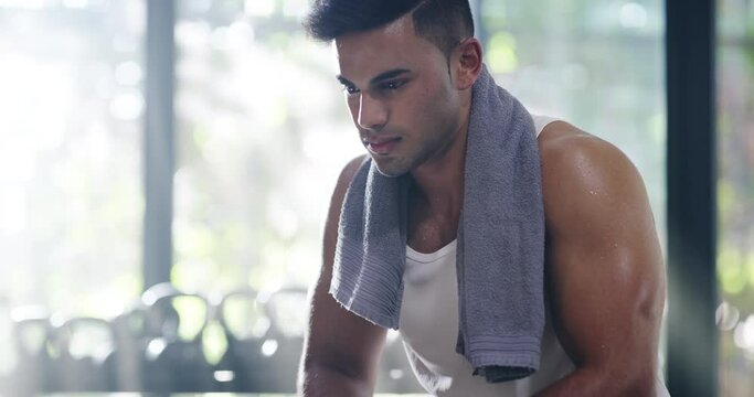 Breathing, exercise and tired man at gym after training, intense performance and thinking. Fitness, break and serious male person relax, focus and determined mindset, rest and workout recover