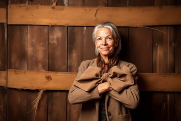 Conceptual portrait photography of a glad mature woman making a formal greeting gesture with a bow against a rustic brown background. With generative AI technology