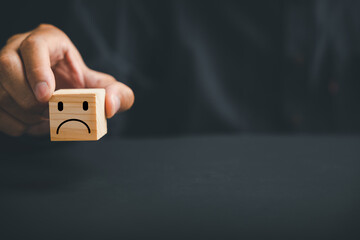 Unsatisfied customer expressing dissatisfaction on a wooden block. Concept of bad product quality,...