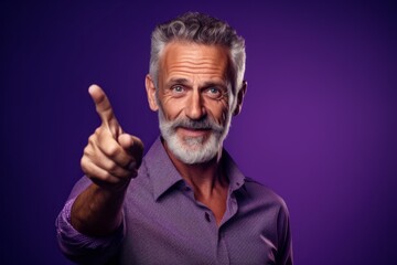 Medium shot portrait photography of a glad mature man making a i have an idea gesture with a finger up against a deep purple background. With generative AI technology