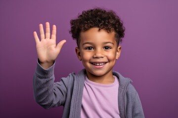 Lifestyle portrait photography of a happy kid male waving with the hand against a lilac purple background. With generative AI technology