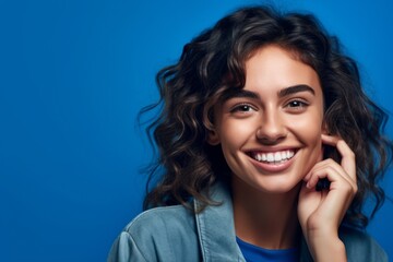 Fototapeta premium Close-up portrait photography of a happy girl in her 20s making a telephone call gesture with the hand against a periwinkle blue background. With generative AI technology