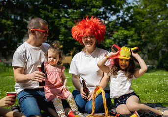 Portrait of a young family with children on a picnic.