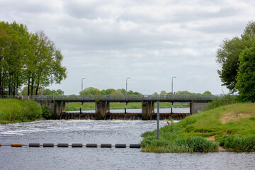 Irrigation concept, The weir (Stuw bij Junne) in the Vecht river, Little dam or water barrier for agriculture between Harderberg and Ommen town, Dutch water management system, Overijssel, Netherlands.