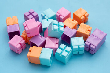 Plastic building blocks on blue background. Top view