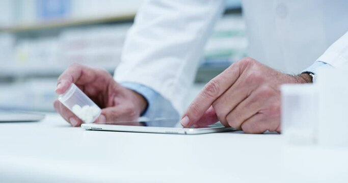 Closeup, hands and pharmacist with pills, tablet and check prescription with update inventory, stock and wellness. Male person, pharmacy and employee with technology, typing and medicine with network