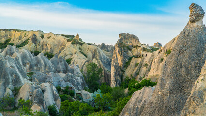 Cappadocia Turkey. Hot air balloons flying over fairy chimneys at sunrise in Cappadocia. Travel to Turkey. Touristic landmarks of Turkiye. Selective focus included.