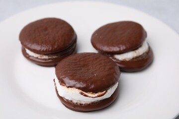 Tasty sweet choco pies on plate, closeup