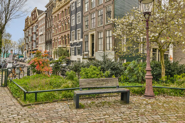 Fototapeta na wymiar a bench in the middle of an urban area with trees and flowers on both sides of the benches are empty