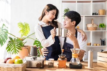 Asian man and woman preparing food and bread to make a healthy breakfast. Enjoying cooking with joy, a charming wife and cheerful husband are preparing delightful meals with fresh ingredients.