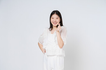 Young woman showing mini heart sign isolated over white background.