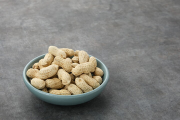 Roasted peanuts on small bowl. Copy space
