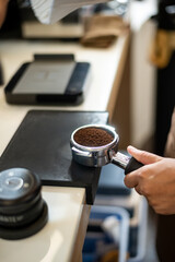 Espresso machine with ground coffee ready to make a drink.