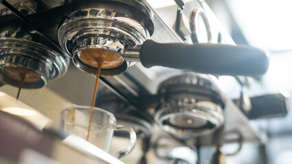 Coffee machine making espresso in coffee shop, shallow depth of field