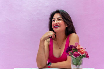 girl dressed in pink blouse for photos on purple background