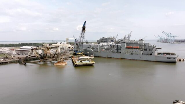 Ships and shipyard in Mobile Bay in Mobile, Alabama with drone video moving left to right.