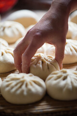 Homemade people making raw steamed buns. Delicious baozi,