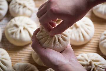 Homemade people making raw steamed buns. Delicious baozi,