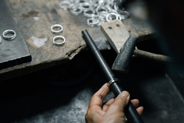 Close-up of craftsman hand making ring made of silver Folk handicrafts of Nan Province, Thailand	