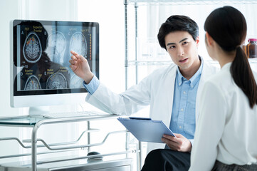 Surgeon talking to patient in examination room