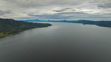 Fototapeta premium Aerial drone of Lake Toba and the coast of Samosir Island. Tropical landscape. Sumatra, Indonesia.