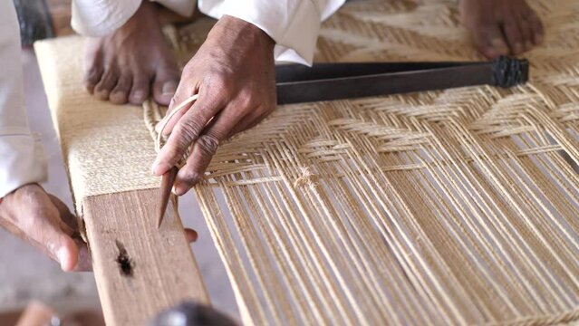 Artisan Weaving To Make Charpai, A Traditional Woven Bed In Sindh, Pakistan
