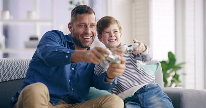 Family, father and son with a video game, couch and bonding with happiness, relax or weekend break. Male child, home or kid with dad, fun and playing online in the living room, console and connection