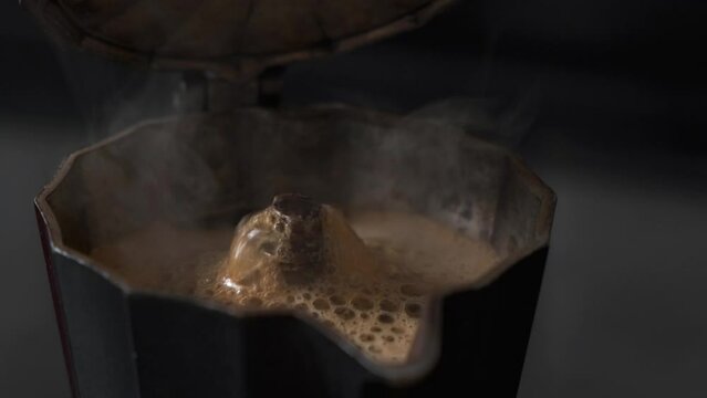 hot fresh coffee comes out of the coffee pot, preparing coffee in the morning, coffee from old coffee pot moka
