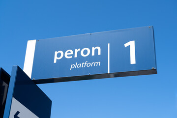 Blue railway station sign in Poland. Train platform number information plate. Letters in Polish...