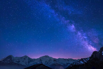 Milky Way and stars in night sky over the Swiss Alps at Lauterbrunnen with Eiger, Monch and Jungfrau peaks
