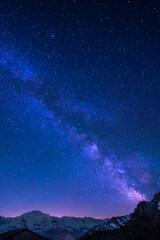 Milky Way and stars in night sky over the Swiss Alps at Lauterbrunnen with Eiger, Monch and Jungfrau peaks