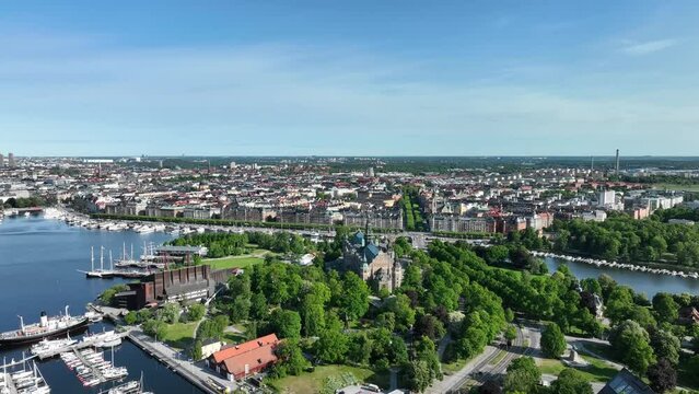 Beautiful descending aerial showing Nordiska Nordic museum and the Djurgarden island in swedens capital Stockholm - Ostermalm and Norra Djurgarden in background