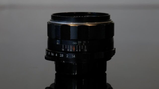 The classic 35&nbsp;mm film camera lens Asahi Pentax Super Takumar 50&nbsp;mm f 1.4 in its first edition (3rd batch) with 8 Elements. Pan and zoom shot for retro and vintage photography and history videos.