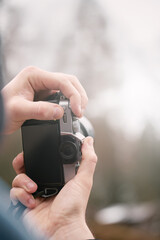 Young Photographer man using Camera to Take Photo. POV Selective focus on LCD Screen mockup