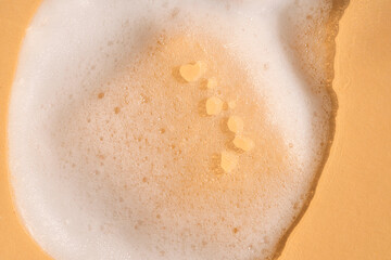 Soap foam on a light beige background.