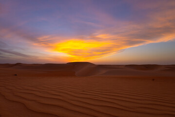 Fototapeta na wymiar Sunset sunrise with beautiful cloud color in the desert sand dune.