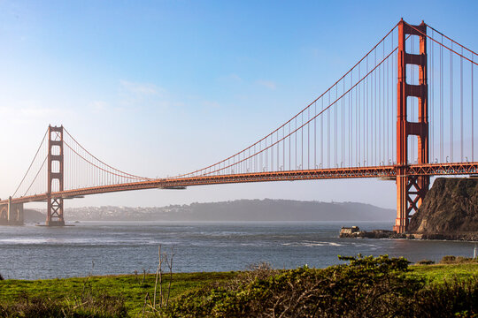 Picture of the Golden Gate Bridge in San Francisco crossing the bay of the Californian city under a blue sky. Famous bridge in the state of California in the United States of America. Concept USA.