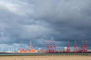 Red cranes  along the port of Liverpool industrial docks Merseyside