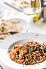 All amatriciana spicy spaghetti with olives, pecorino cheese and tomatoes