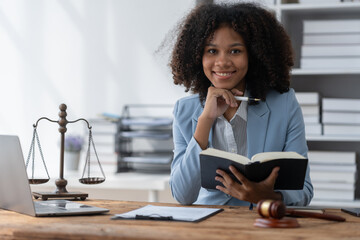 American woman lawyer or businesswoman African working with laptop, searching, analyzing data,...