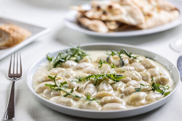 Creamy gnocchi with four types of cheese and ruccola on top