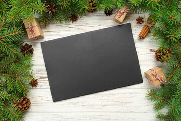 top view. Empty black slate rectangular plate on wooden christmas background. holiday dinner dish...