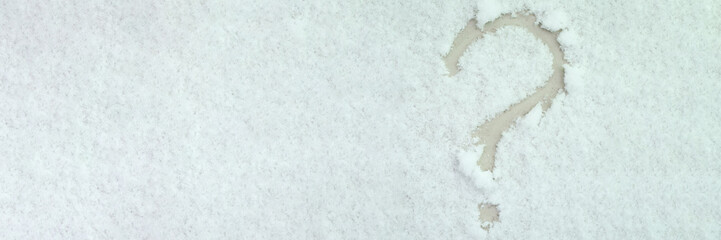 Question mark painted on white snow closeup. Changeable air temperature in winter concept