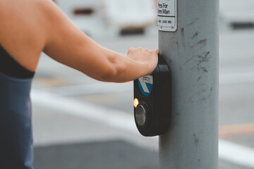 Traffic light, A woman hand push button pedestrian on the pole while waiting for the red light,...
