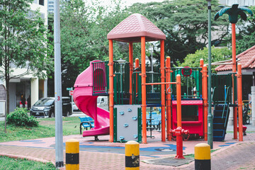 Rubber Children Playground with Red Slides in Public Housing in Singapore.