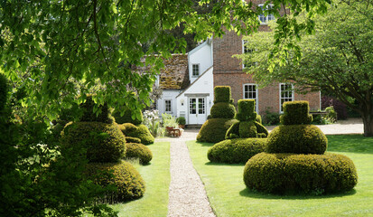 The Manor House at Hemmingford Grey with its impressive topiary.