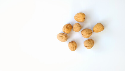 Walnuts on a bright white background with natural lighting. Healthy food, and one of the symbols for the Passover holiday and also for the Tu Bishvat holiday. top. with free space for text